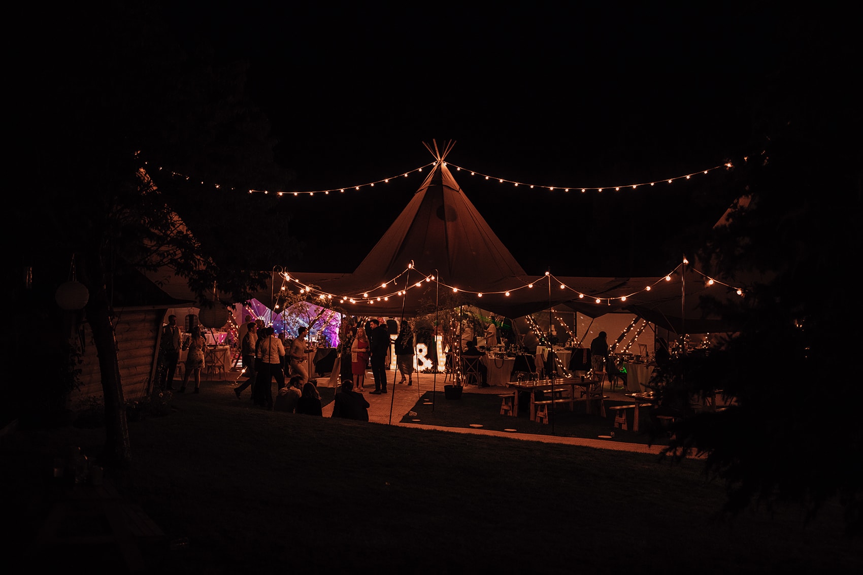 wedding tipi with fairy lights in the dark