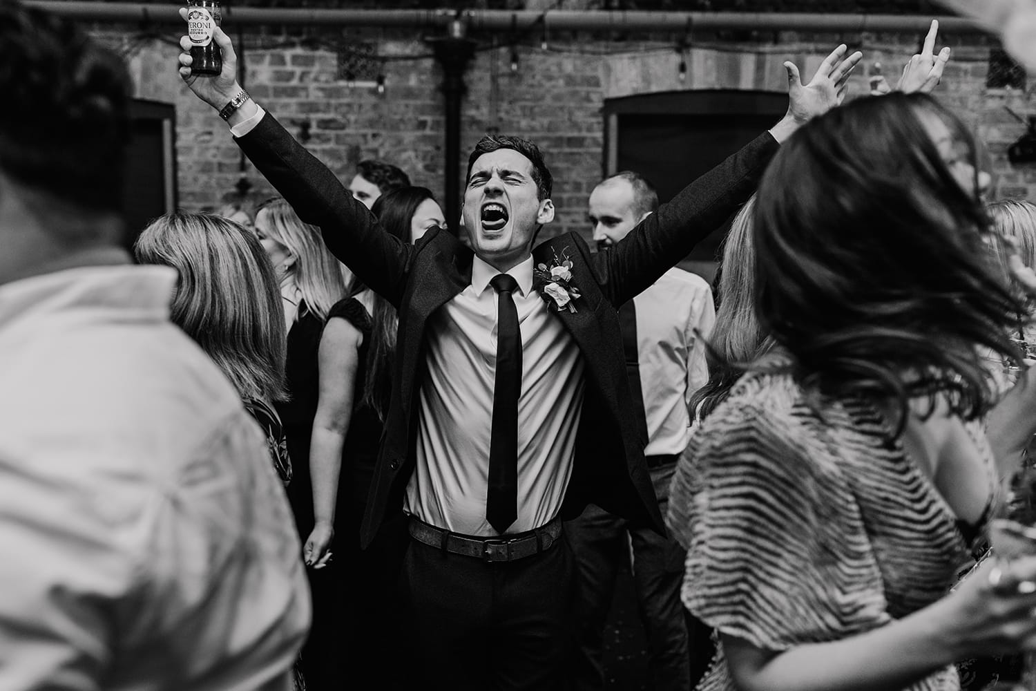 Black and white photograph of a wedding guest dancing
