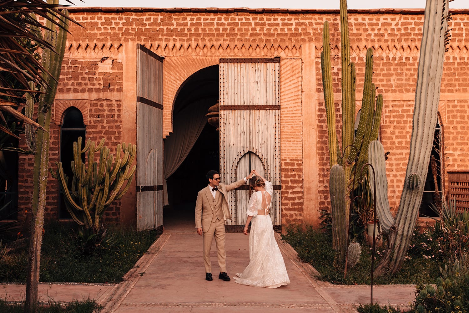 Bride and Groom dncing under a giant cactus in Marrakesh