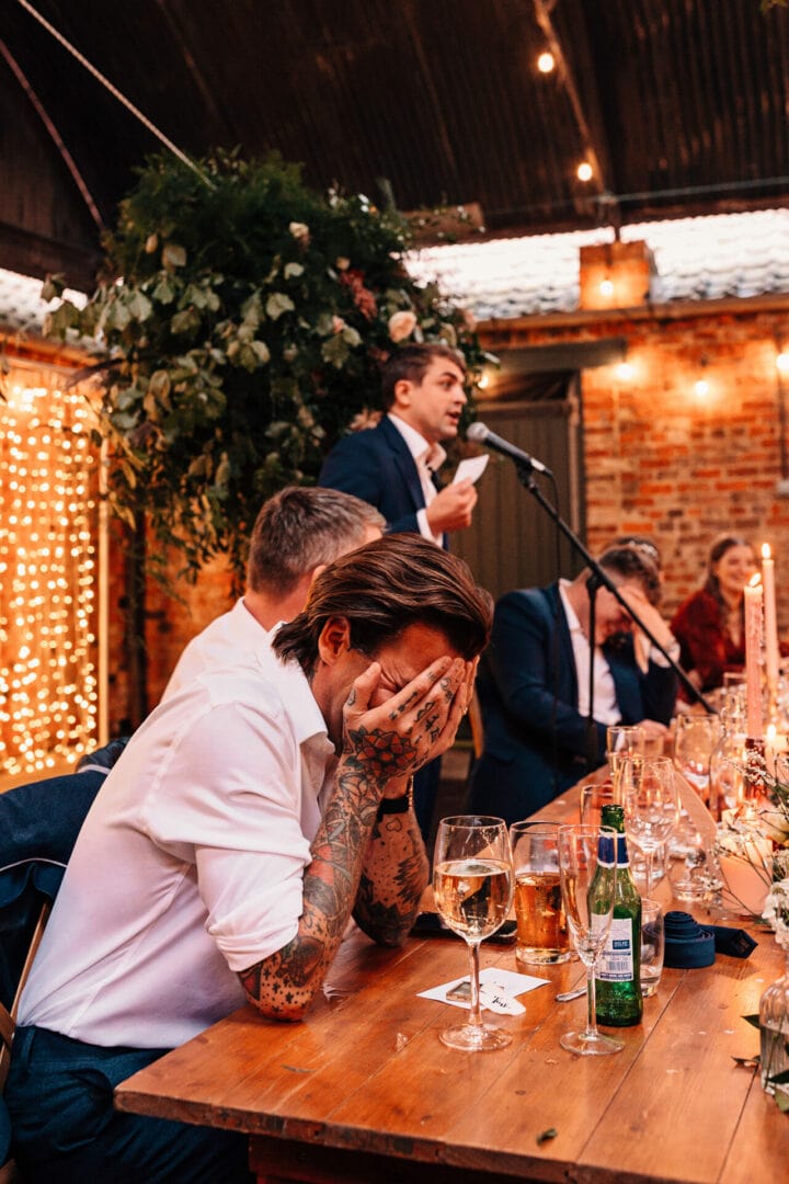 Best man hides head laughing during wedding speeches