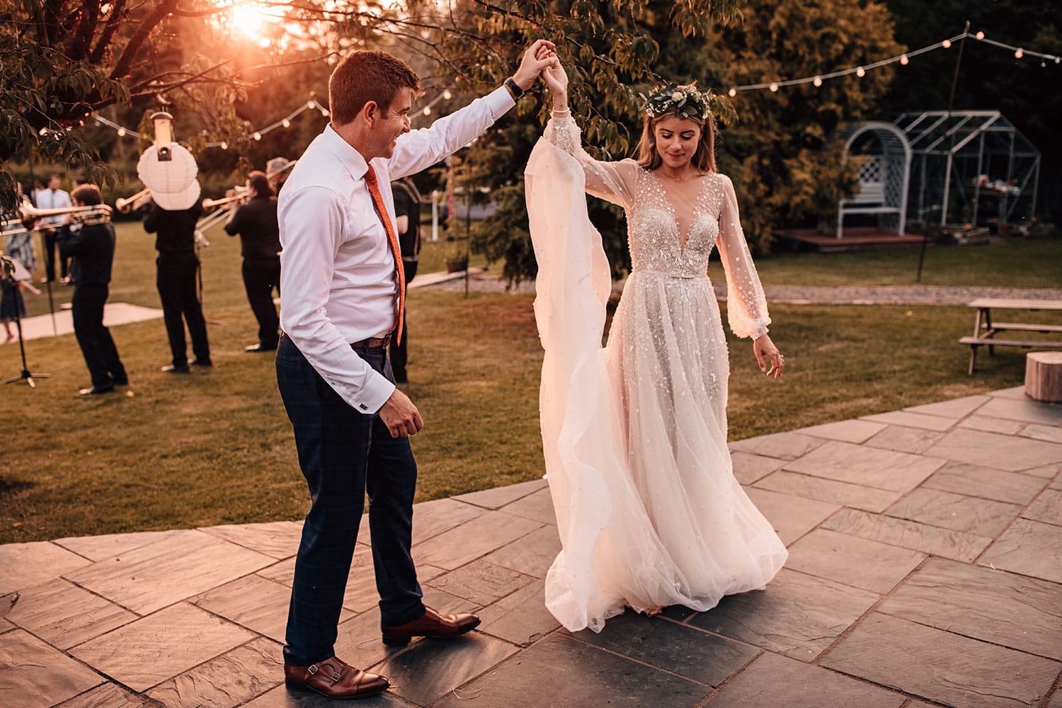 Bride and Groom dancing as the sunset behind them during their outdoor first dance